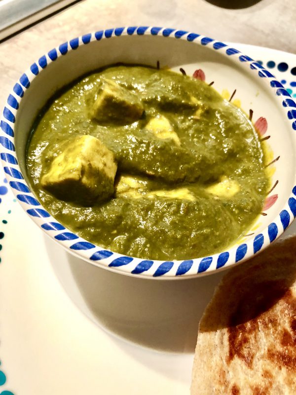 Paneer or cottage cheese cubes in a spinach curry