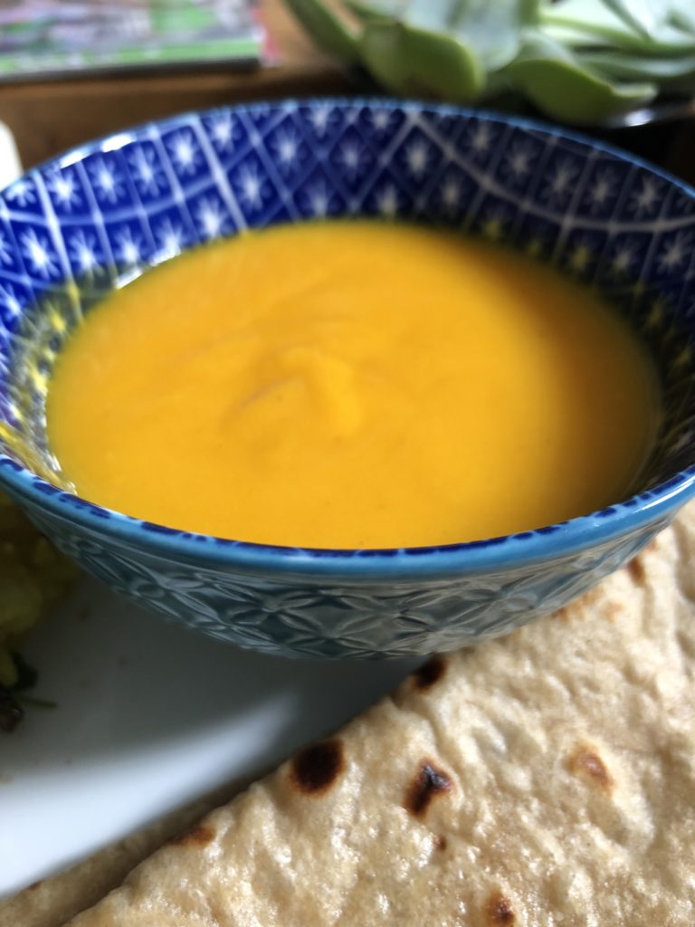 Mango pulp in a blue bowl and roti