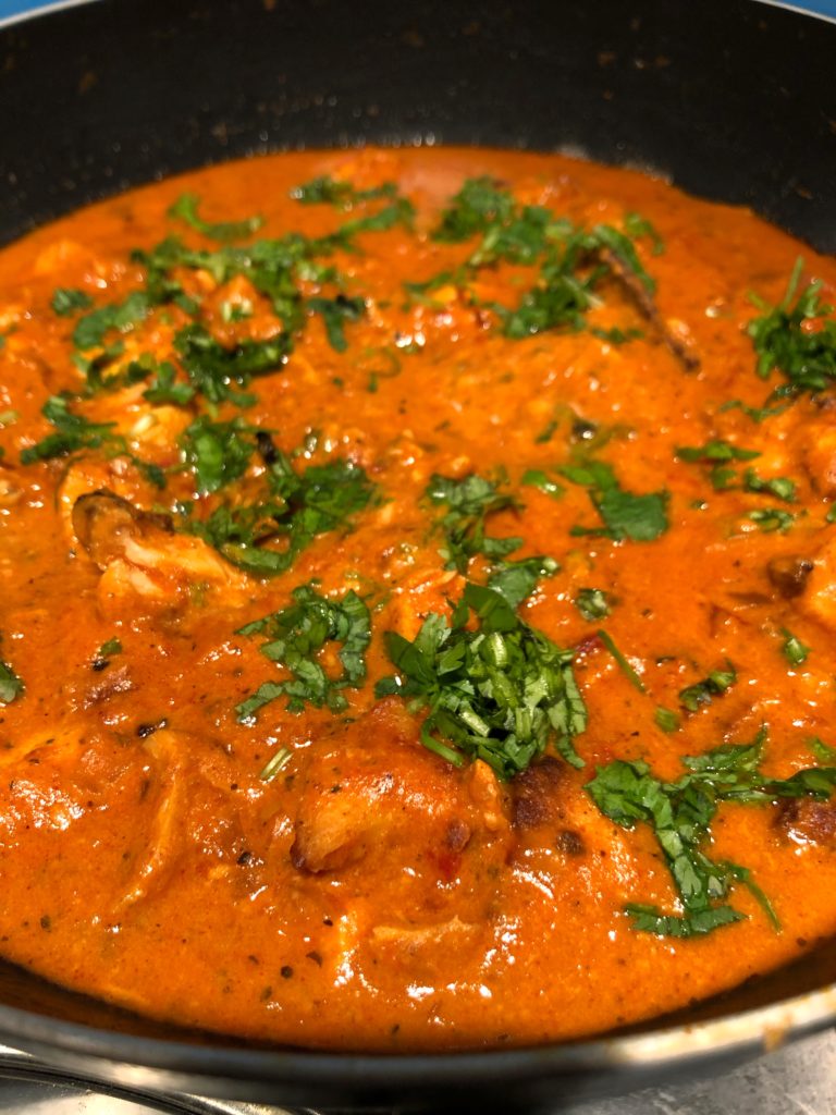 Butter chicken a tangy buttery chicken dish garnished with coriander leaves