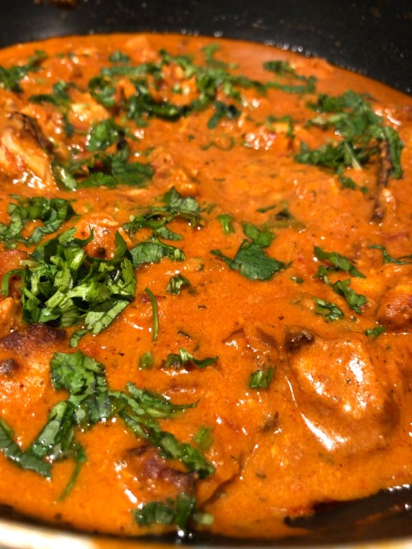 Butter chicken a tangy buttery chicken dish garnished with coriander leaves