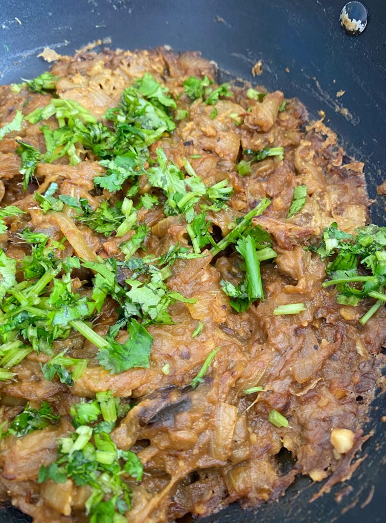 Vangyache bhareet or aubergine mash made with aubergines, peanuts and jaggery garnished with coriander leaves