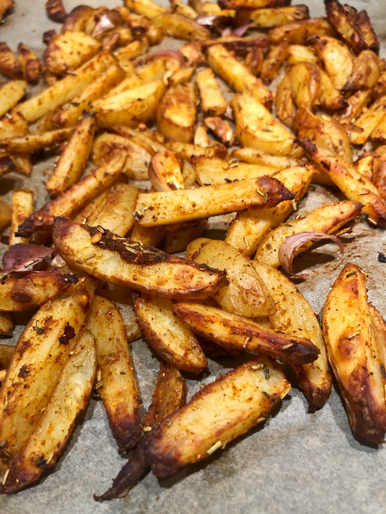 Baked potatoes wedges with seasoning of rosemary, thyme and garlic