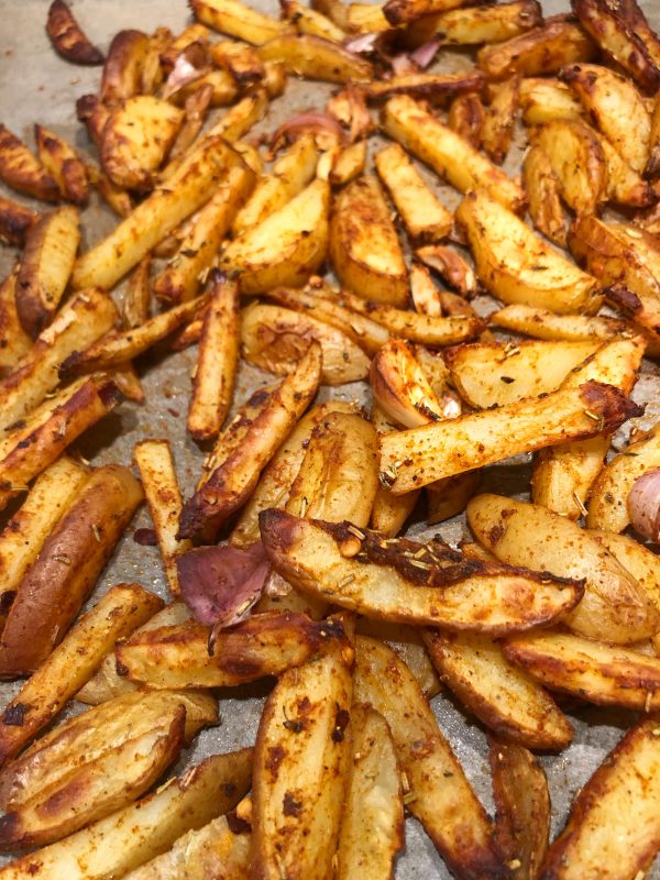 Baked potatoes wedges with seasoning of rosemary, thyme and garlic