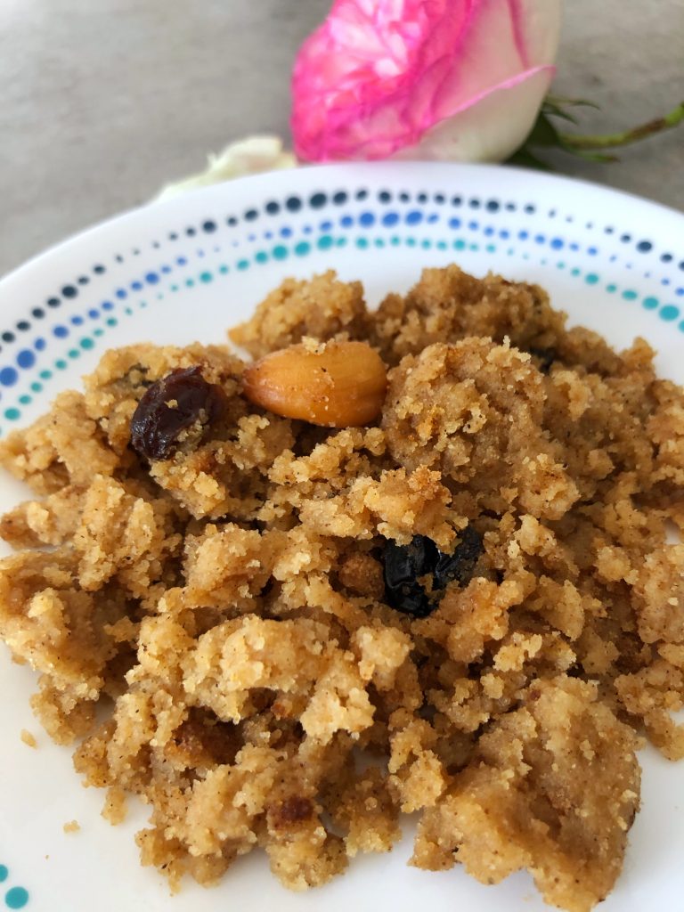 Sheera, a semolina ghee pudding garnished with roasted cashews and raisins